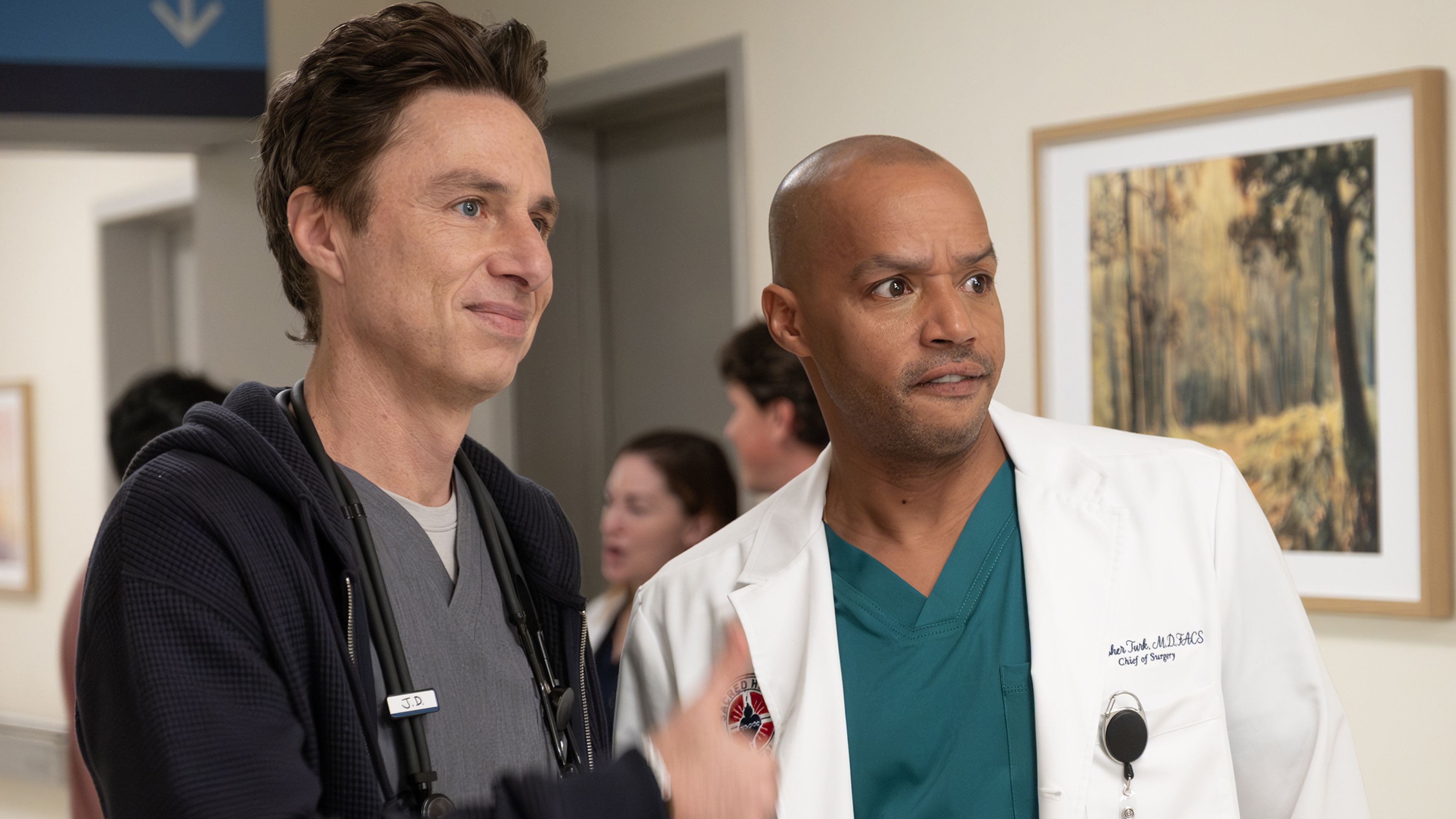 JD and Turk standing together in the Scrubs revival