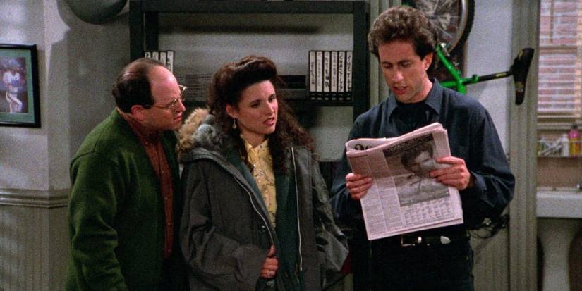 Jerry, George und Elaine schauen sich in Seinfeld eine Zeitung an
