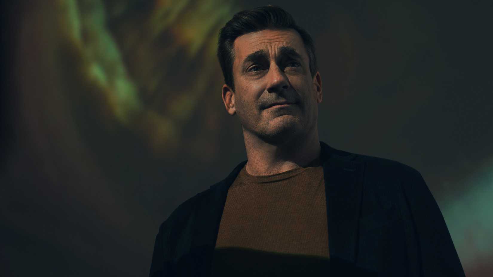 Jon Hamm as Coop looking off to the side and smiling a bit in Your Friends and Neighbors