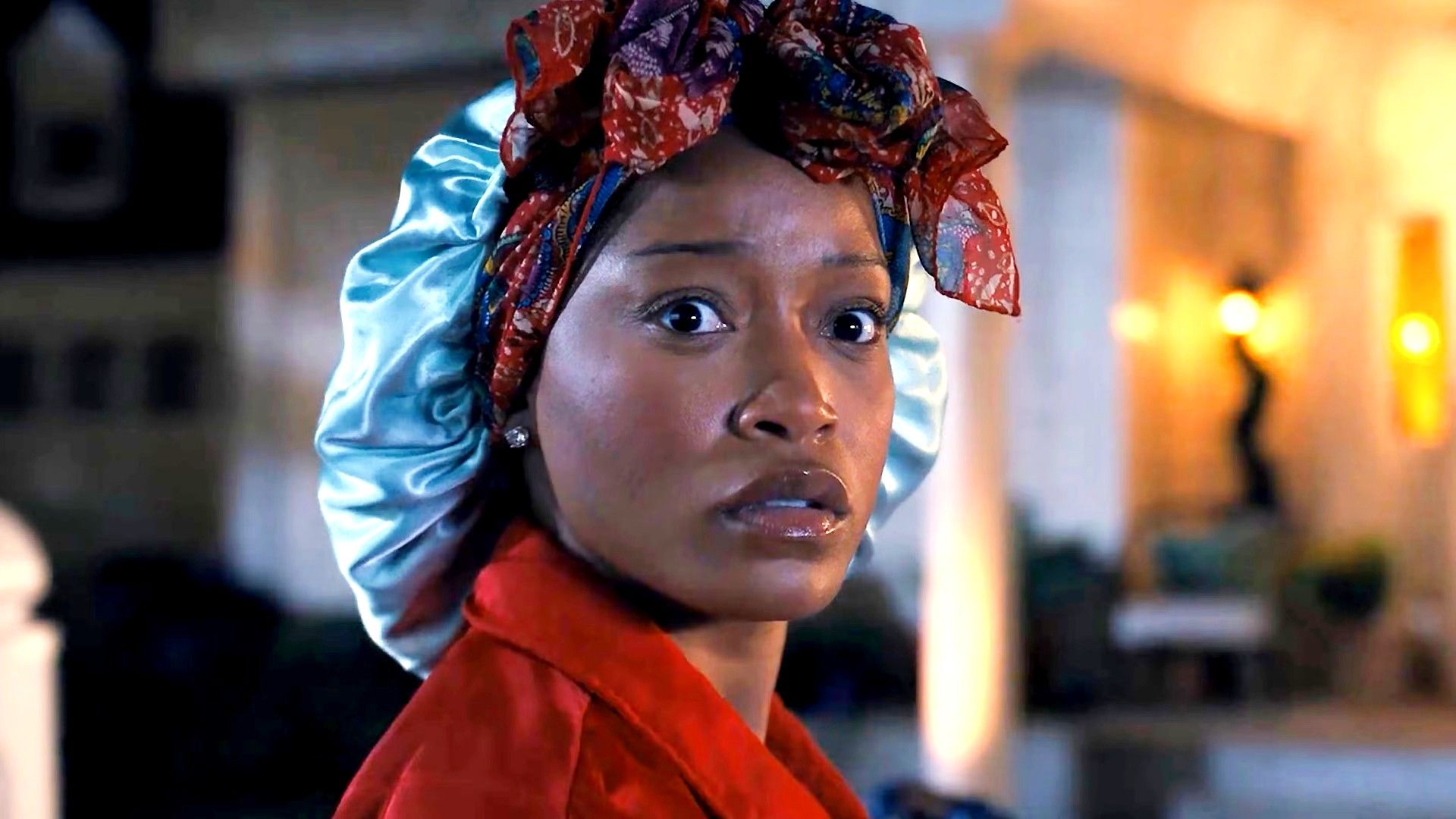 Keke Palmer's Samira looking worriedly over her shoulder while in a nightcap in The 'Burbs