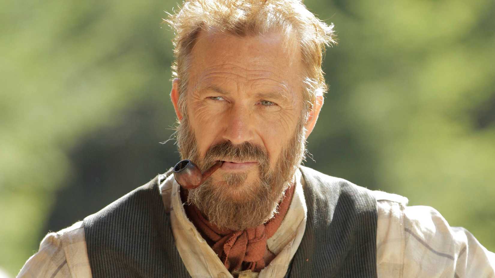 Kevin Costner's Devil Anse smoking a pipe in Hatfields & McCoys