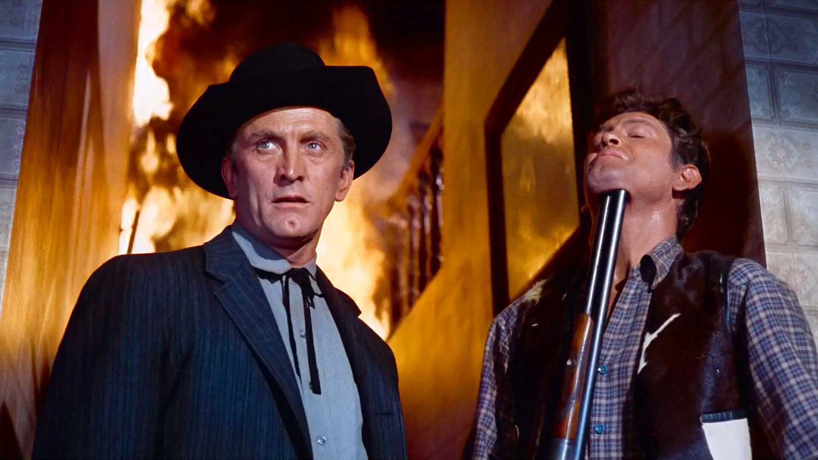 Kirk Douglas holds a prisoner with a shotgun in Last Train from Gun Hill