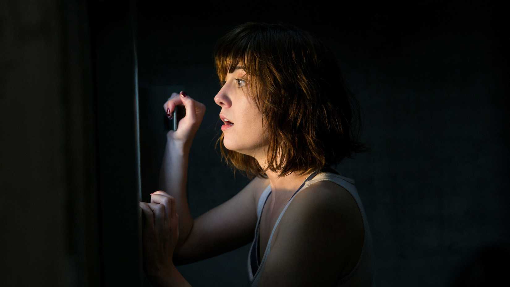 Mary Elizabeth Winstead looking out the door window in 10 Cloverfield Lane