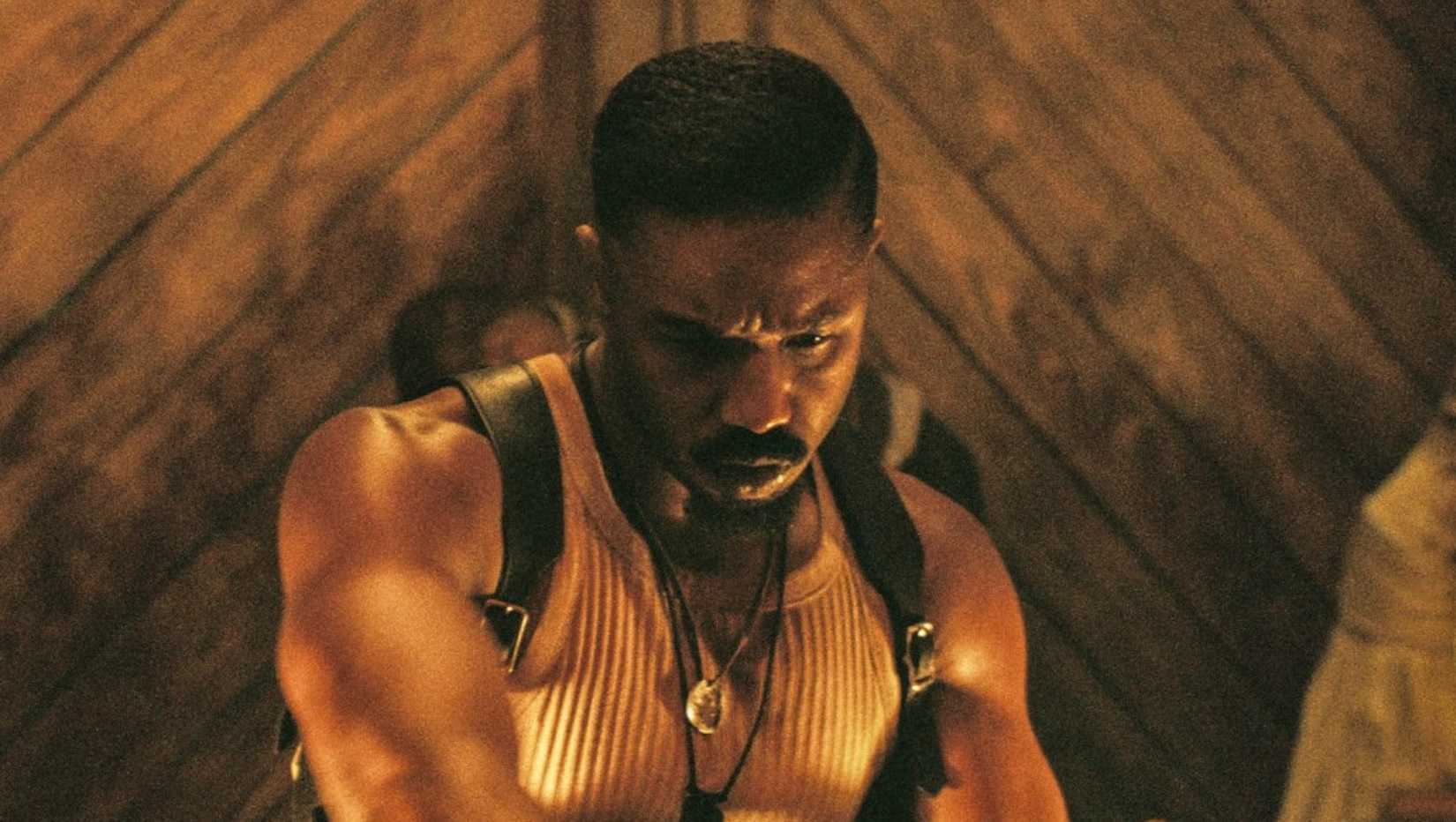 Michael B Jordan sharpens a weapon in Sinners