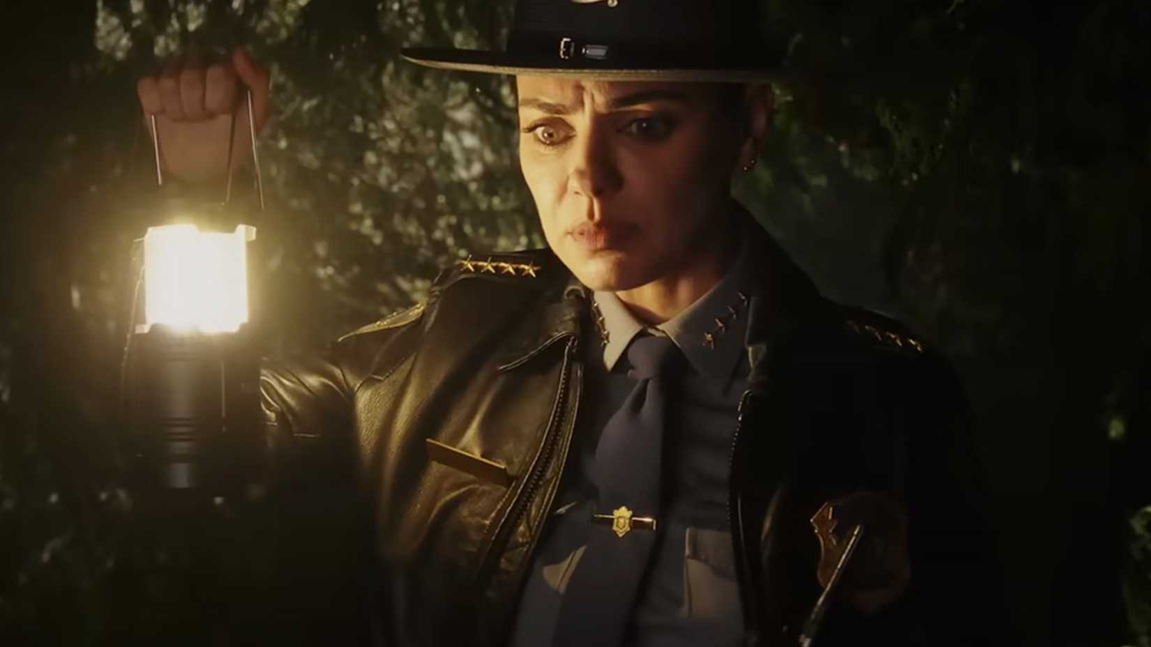 Mila Kunis as Geraldine holding up a light in Knives Out Wake Up Dead Man.