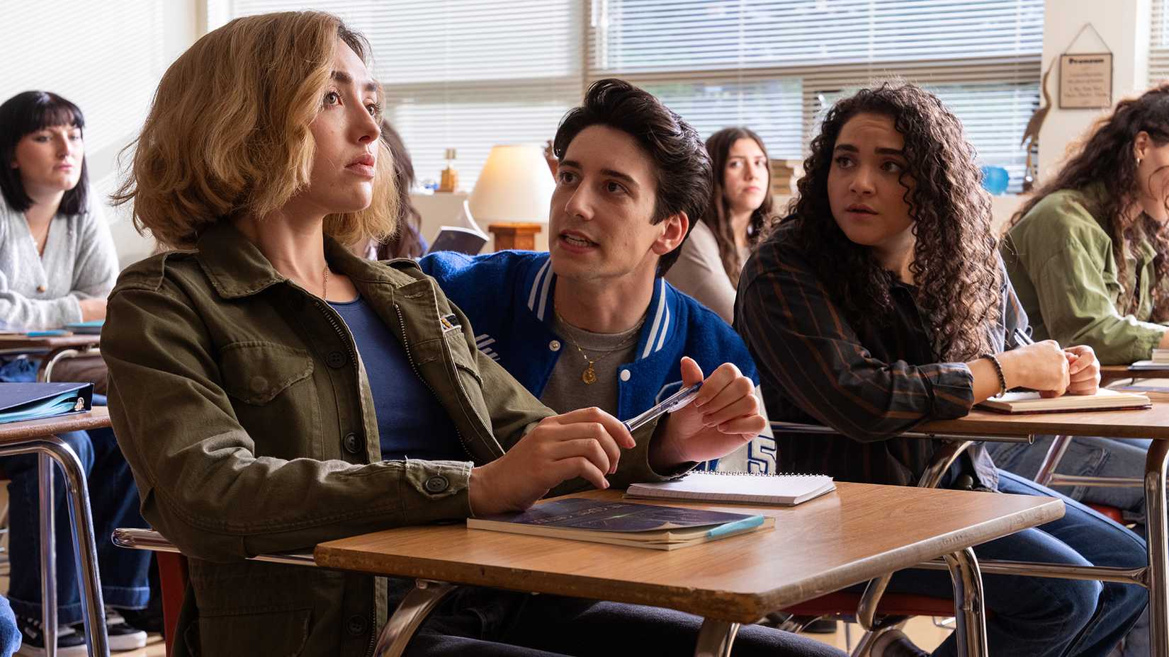 Milo Manheim talking to Peyton List in class in School Spirits season 3