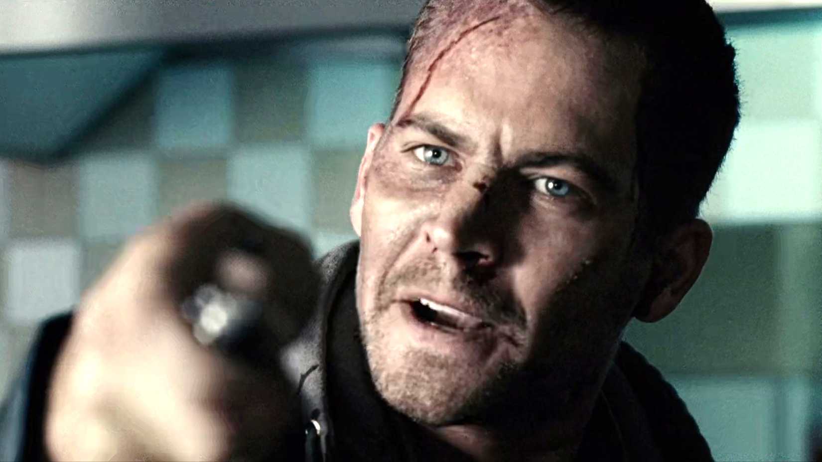 Paul Walker's Joey Gazelle holding a knife angrily toward the camera in Running Scared