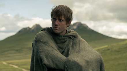 Dunk sitting in a field in A Knight of the Seven Kingdoms