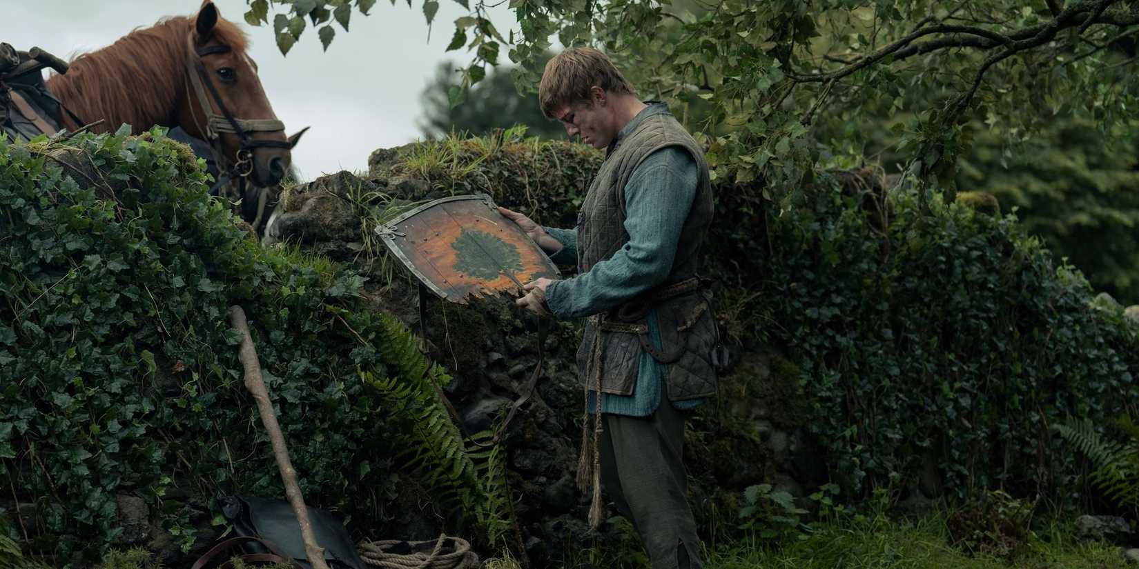 Dunk (Peter Claffey) looking at his shield in A Knight of the Seven Kingdoms episode 6.