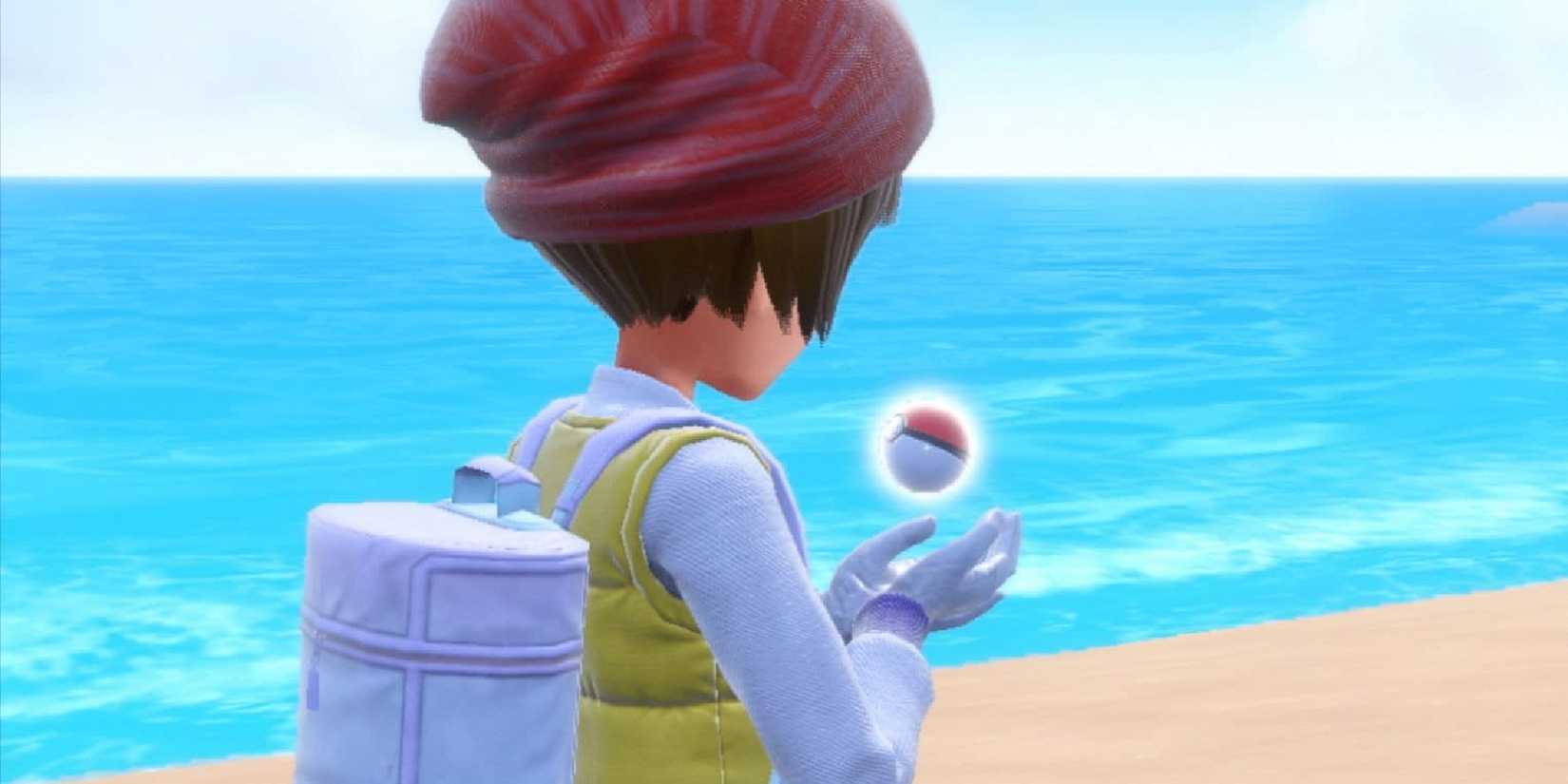 Pokemon purple character holding a monster ball on the beach