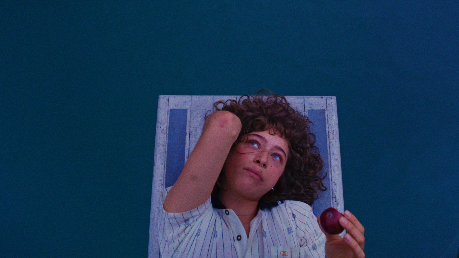 Odessa A'zion as Kennedy laying on a diving board in Pools (2025)