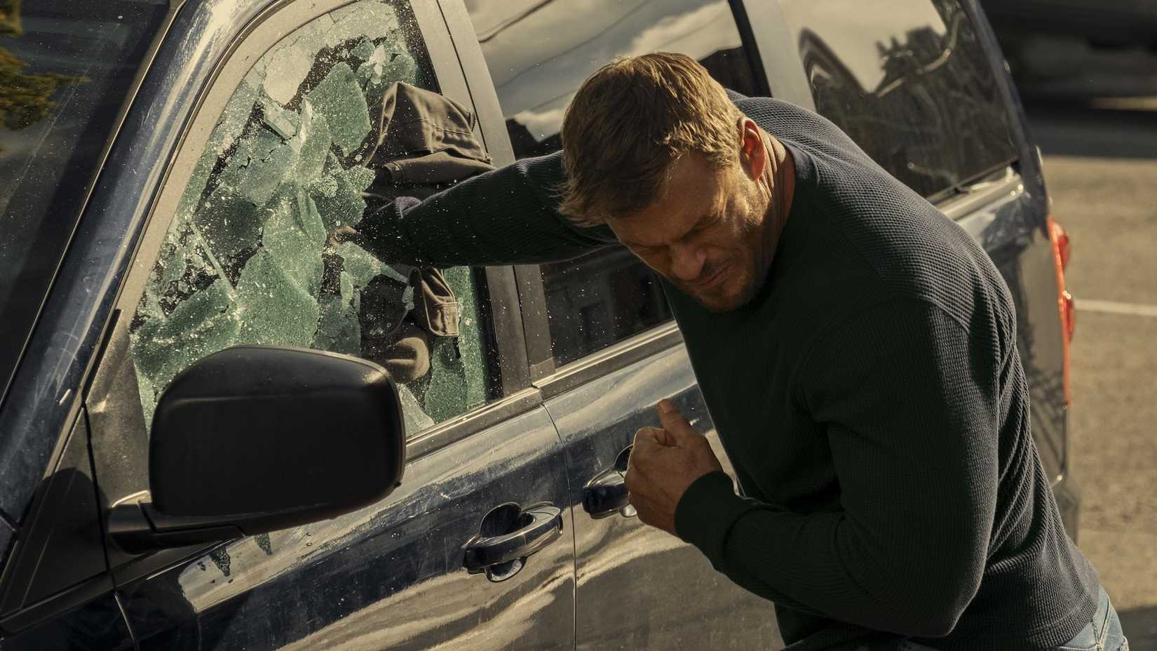 reacher punches through a car window in reacher