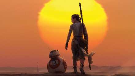 Rey and BB-8 standing in front of a sun in Star Wars The Force Awakens
