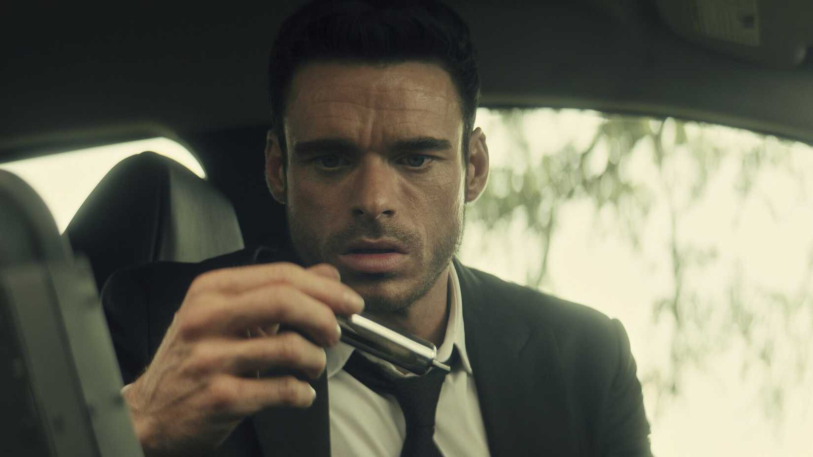 richard madden looking at a vile in a car in citadel season 1