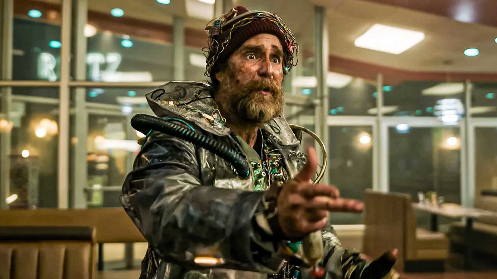 Sam Rockwell as The Man looking worried while pointing at something in Good Luck, Have Fun, Don't Die