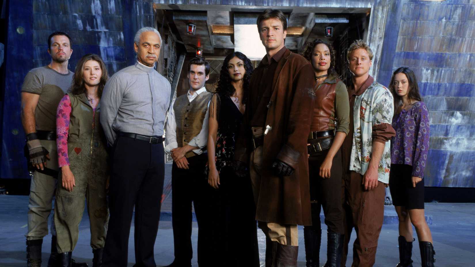 Still of the cast from Firefly in front of the spaceship.