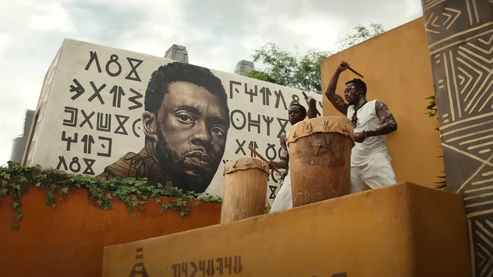 A mural of T'Challa rises above Wakanda in a scene from Black Panther 2