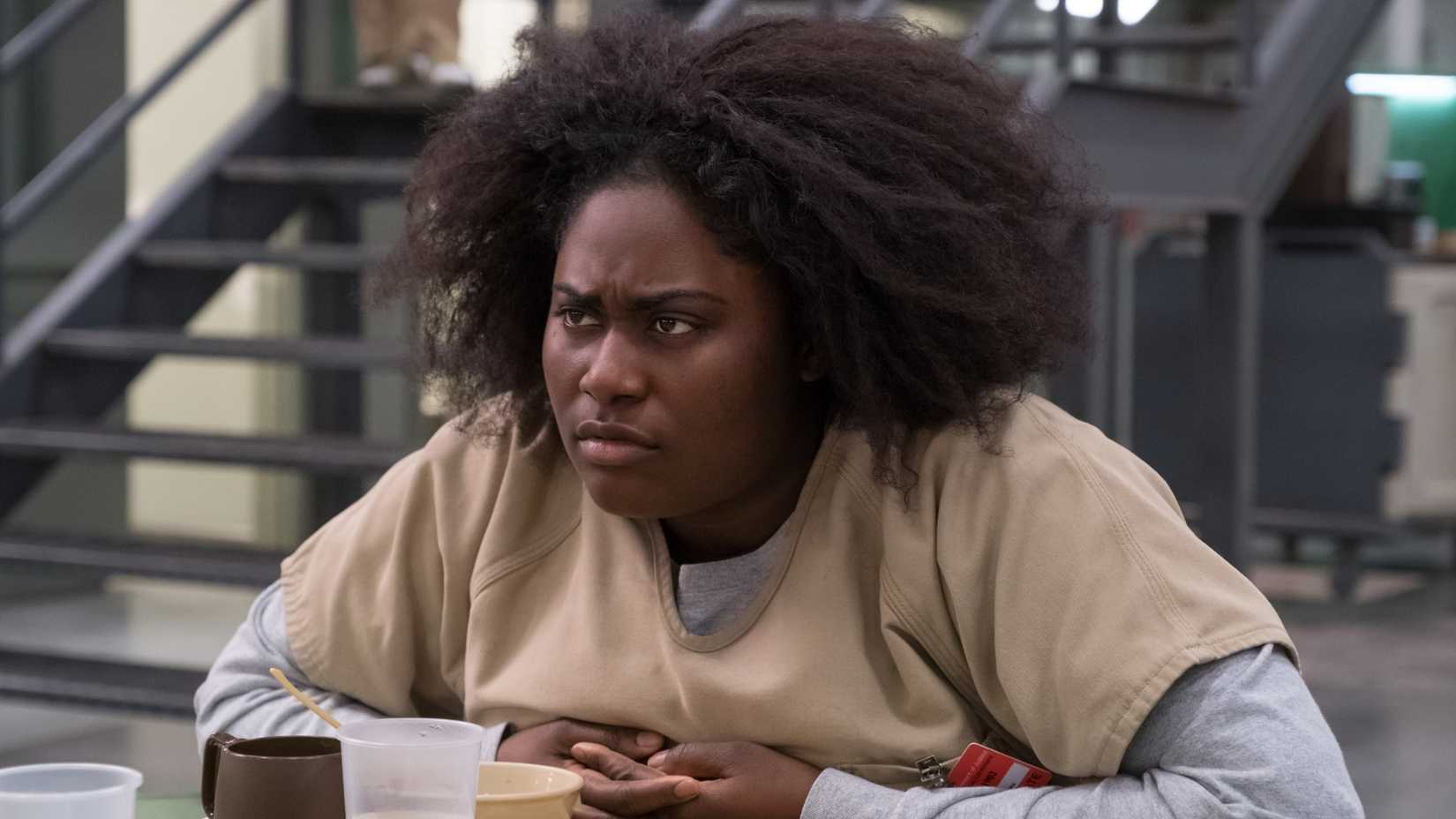 taystee jefferson danielle brooks sitting in a cafeteria in orange is the new black