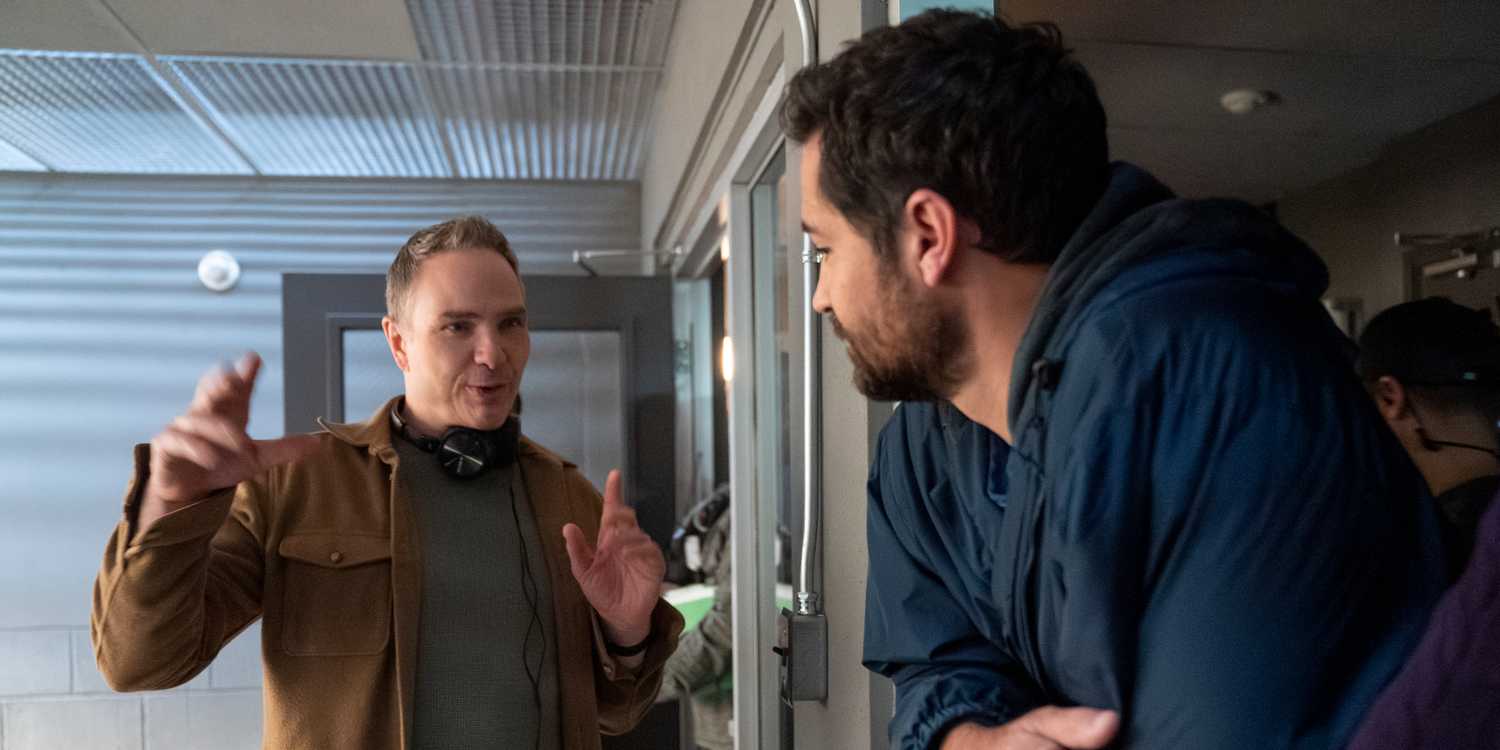 Ted Humphrey speaking with Manuel Garcia Rulfo behind the scenes of The Lincoln Lawyer season 4