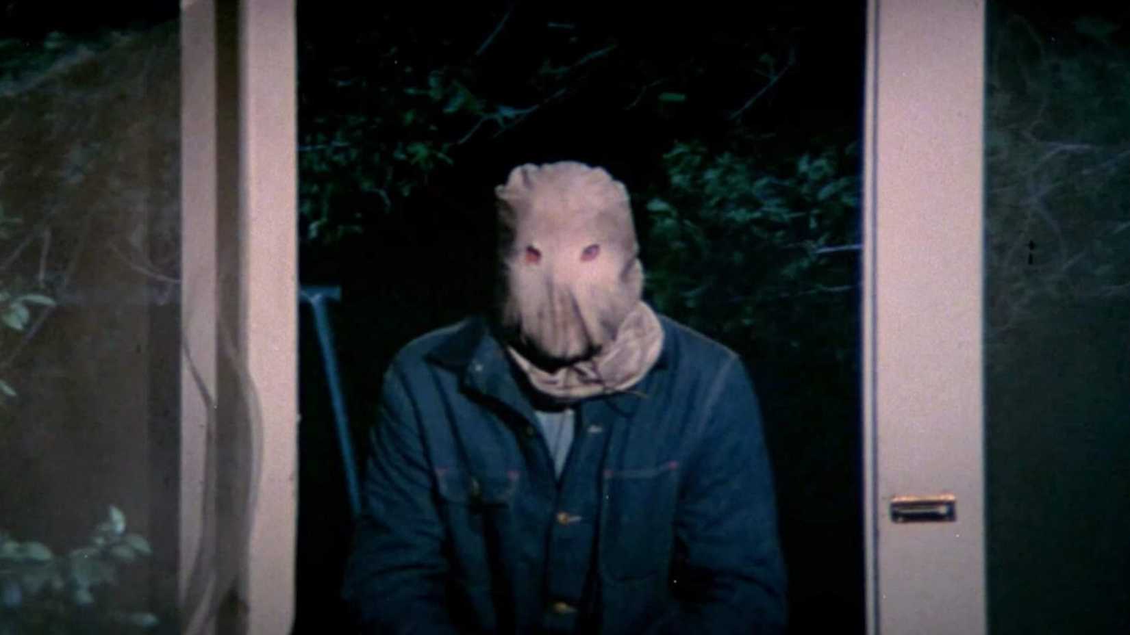 The Phantom Killer looks through a doorway in The Town That Dreaded Sundown