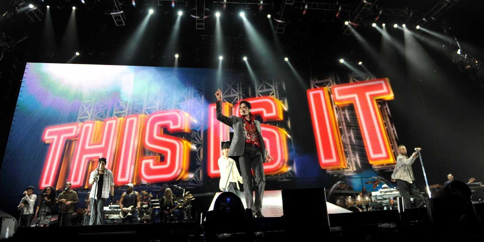 Michael Jackson standing in front of the This Is It sign.