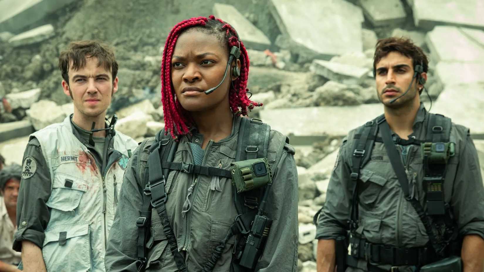 three characters standing by rubble in alien earth
