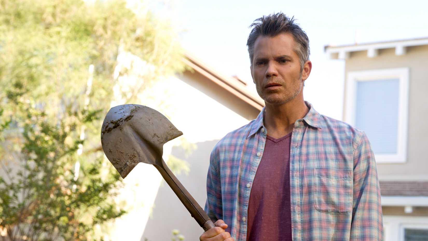 Timothy Olyphant as Joel Hammond holding a shovel in Santa Clarita Diet