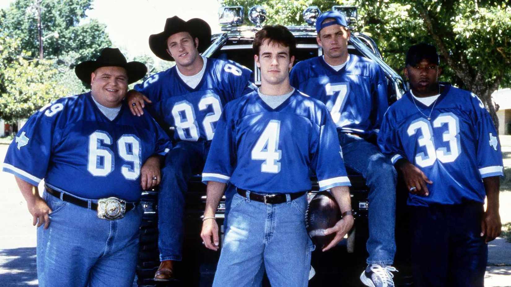 Die Besetzung der Varsity Blues posiert auf einem Lastwagen mit passenden Uniformen 