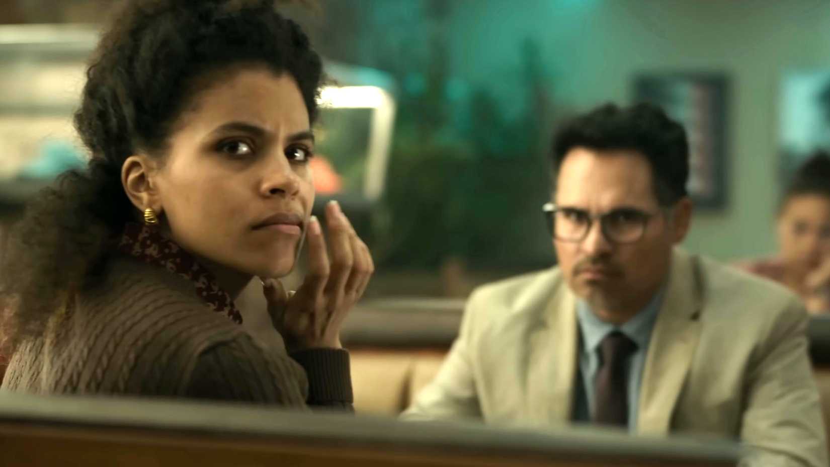zazie beetz s janet and michael pen a s mark looking intensely while in a diner booth in good luck have fun don t die
