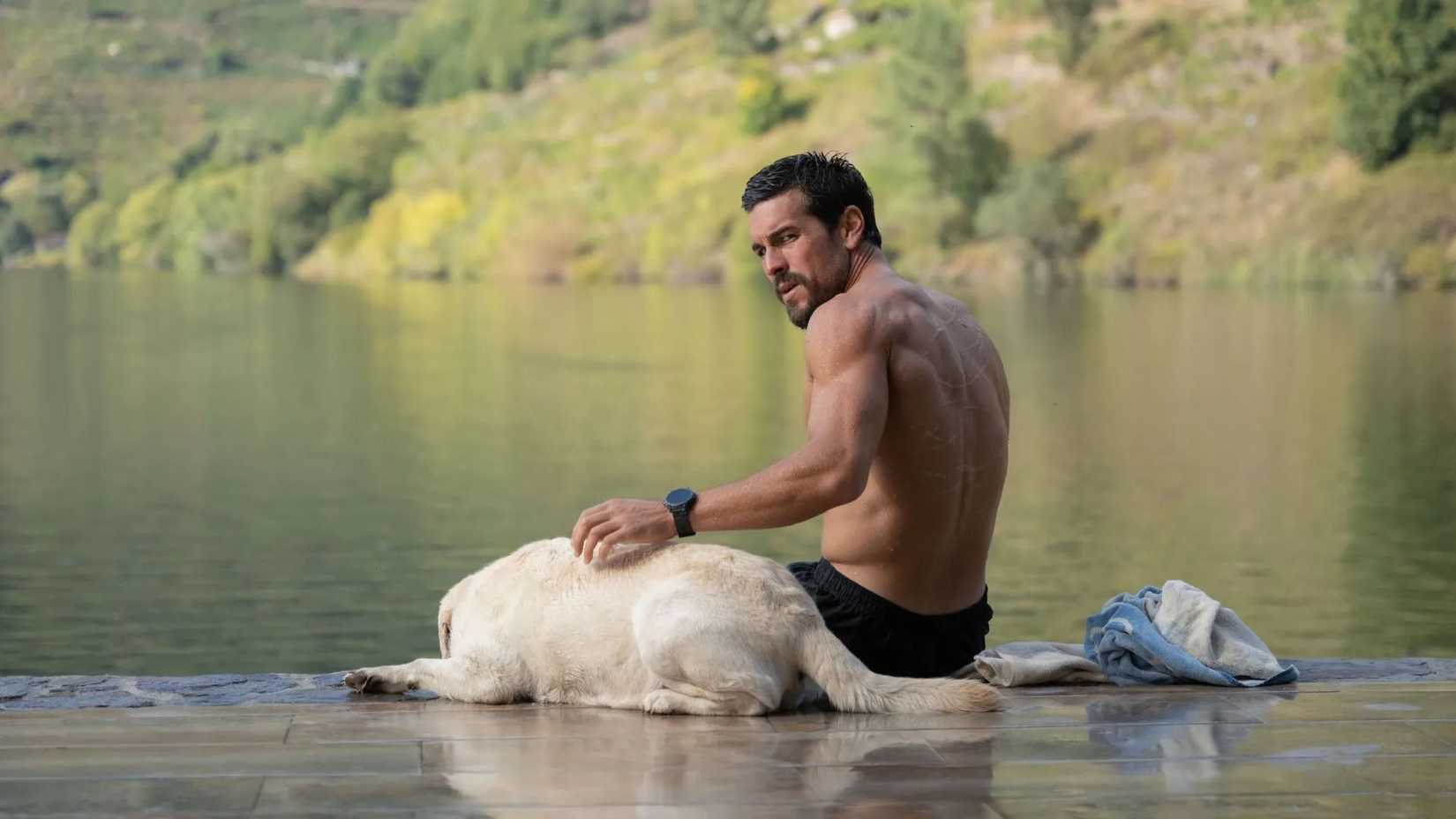 Agent Zeta with his dog sitting by a lake