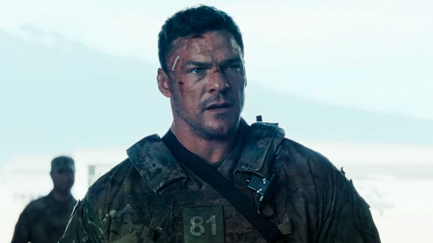 Alan Ritchson as 81 in War Machine looking off-screen