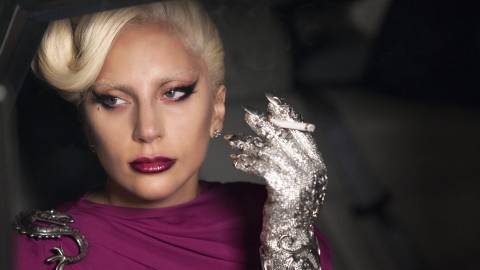 Lady Gaga holding a cigarette in a car in American Horror Story