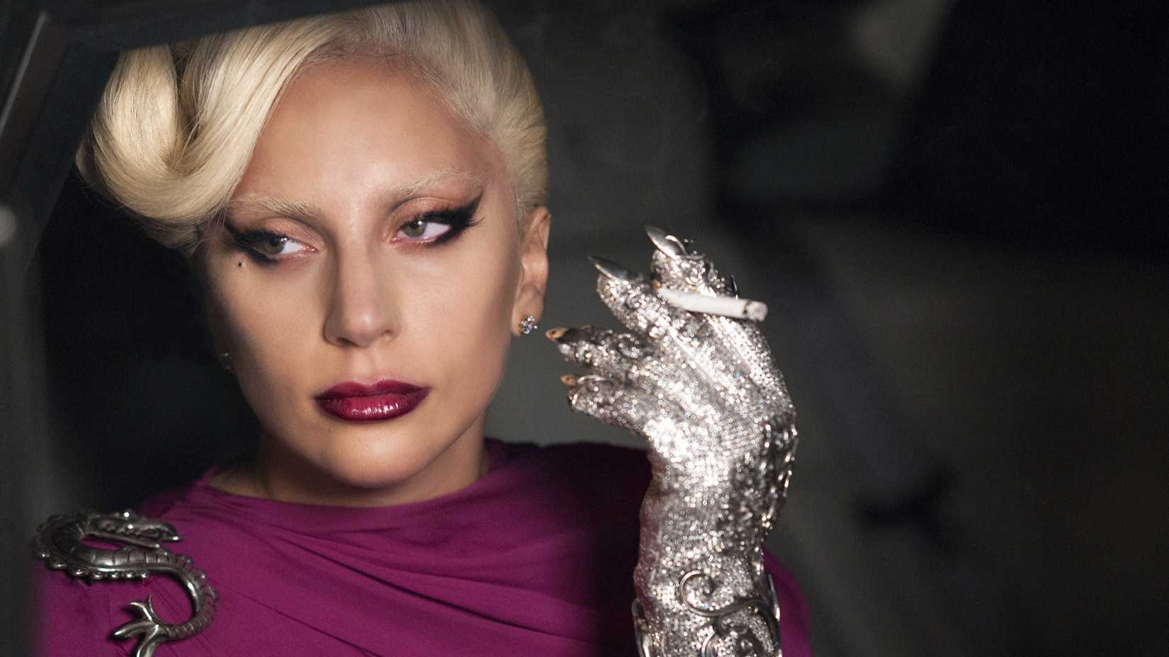 Lady Gaga holding a cigarette in a car in American Horror Story