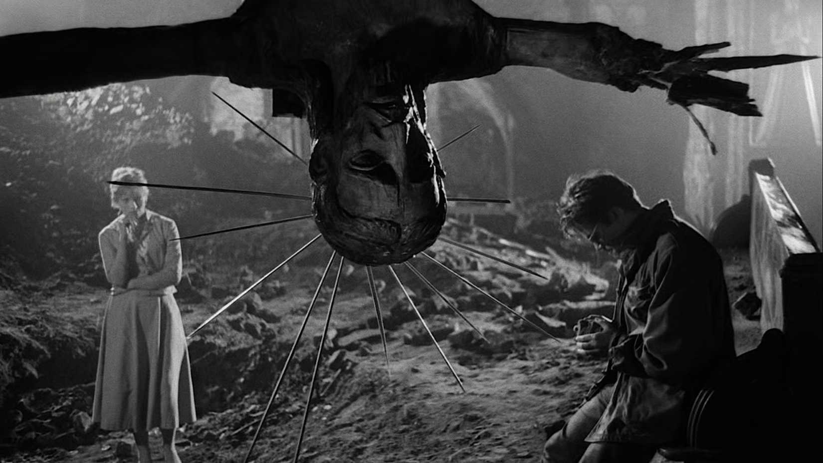 10 Great Movies Recommended by Hayao Miyazaki 7 A statue hangs between two people talking in Ashes and Diamonds