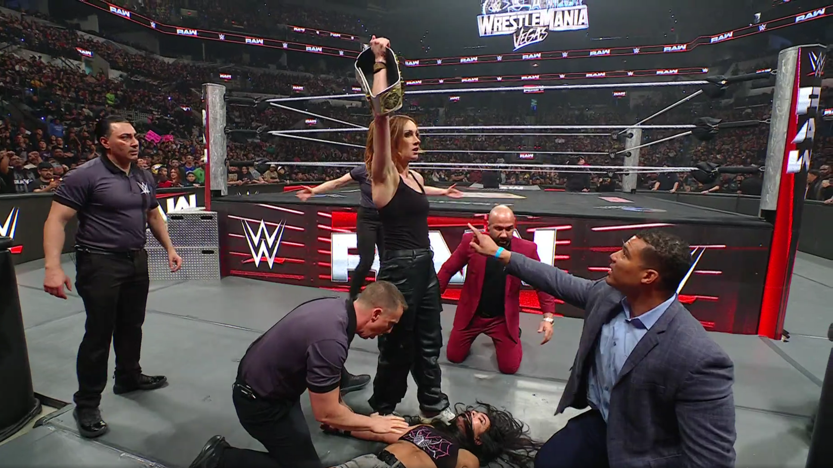 Becky Lynch stands over AJ Lee