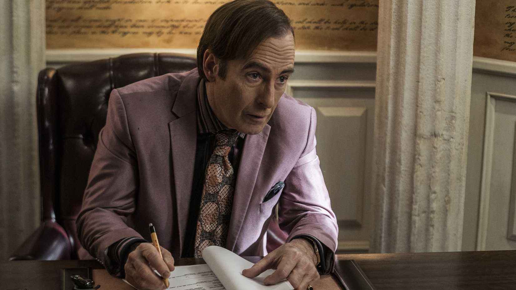 Bob Odenkirk as Saul Goodman leaning forward in his office in Better Call Saul