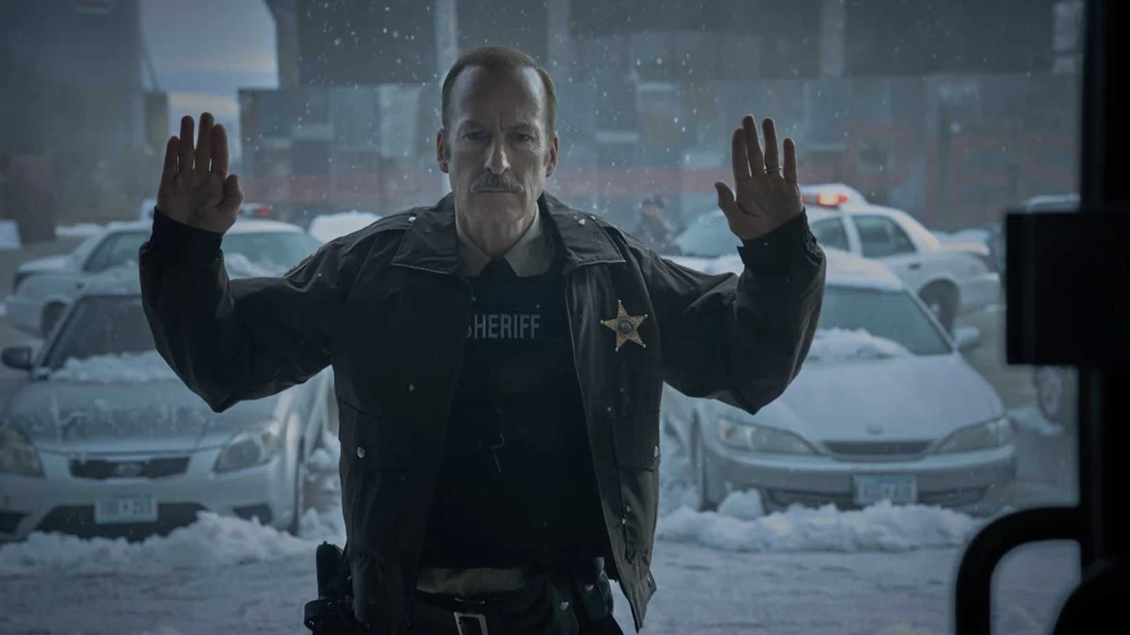 Bob Odenkirk holding his hands up in surrender in Normal