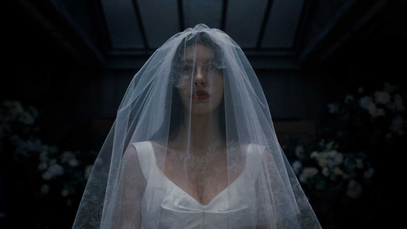 camila morrone as rachel harkin wearing a wedding dress and veil in something very bad is going to happen
