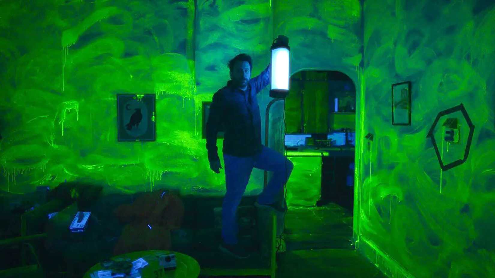 charlie s jimmy pierce holding a blacklight and looking worried about a room full of bleach scrubs in kill me