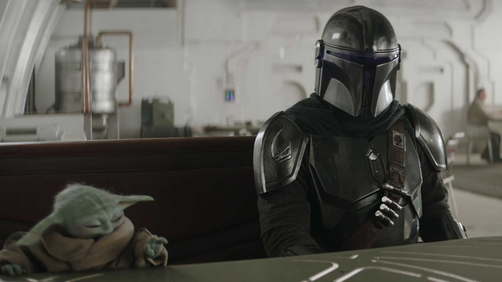 Din Djarin and Grogu sitting across from Ward in The Mandalorian and Grogu