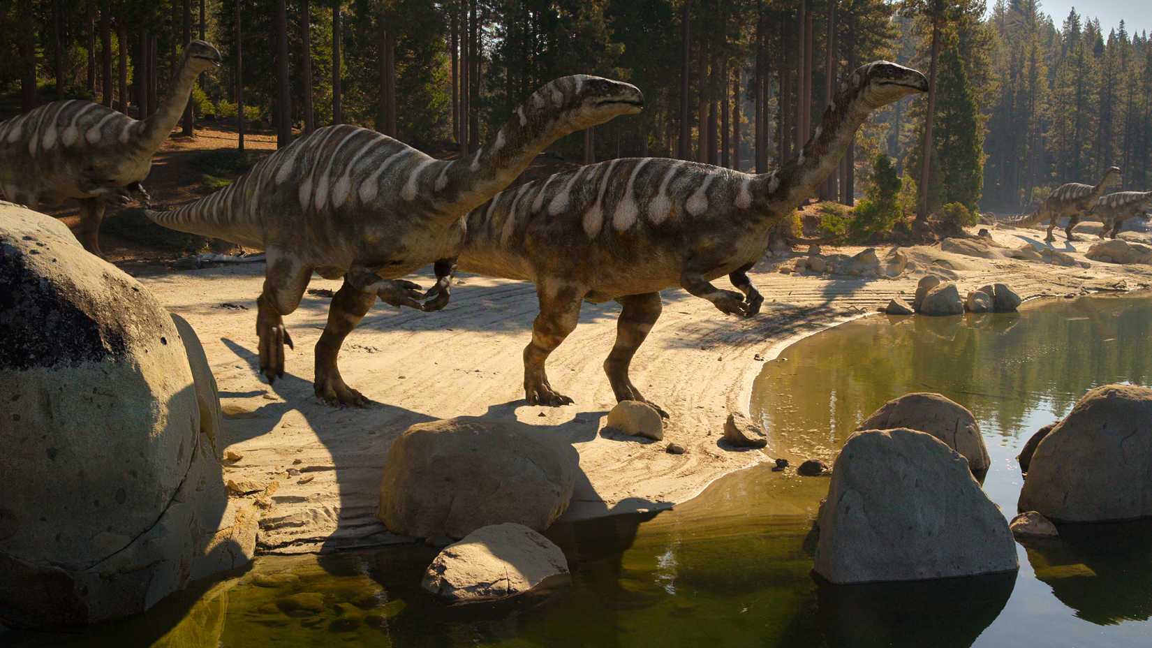 Dinosaurs stand by the water in Netflix's The Dinosaurs
