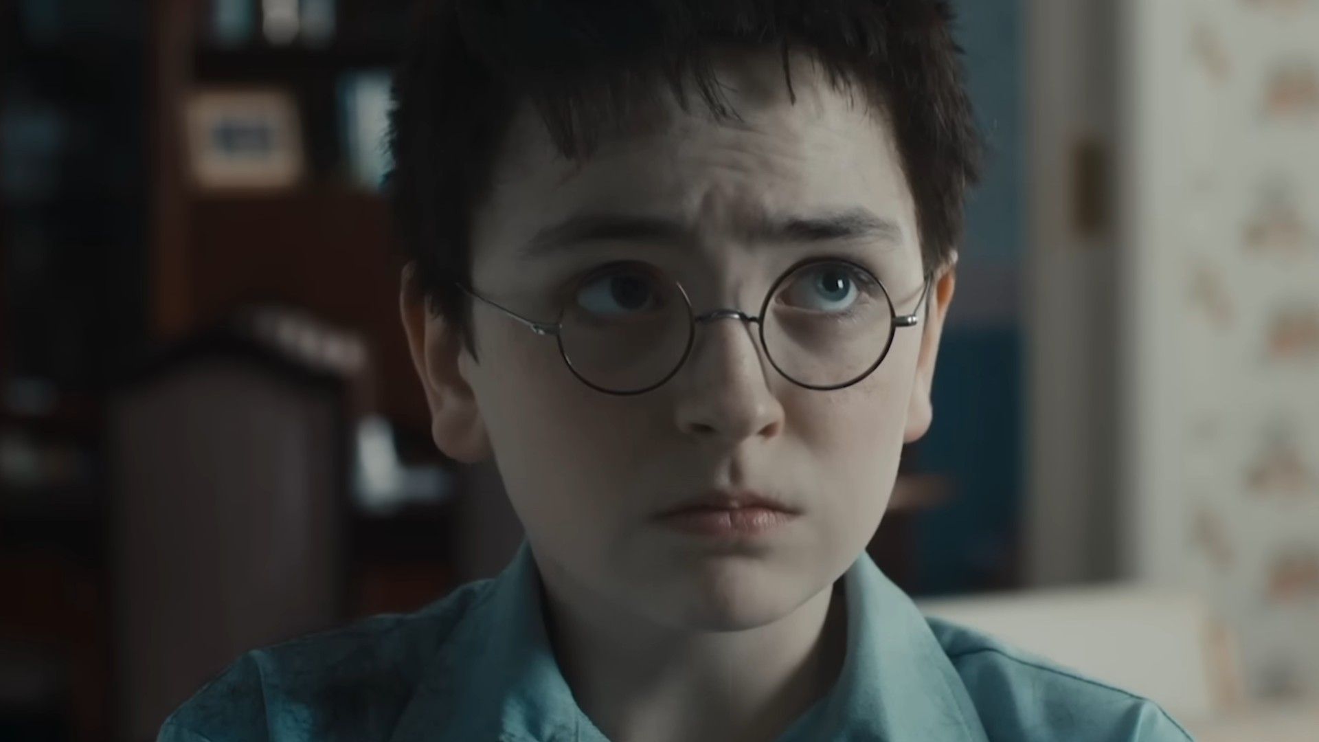 Dominic McLaughlin as Harry Potter looking sad and scared in the Harry Potter trailer