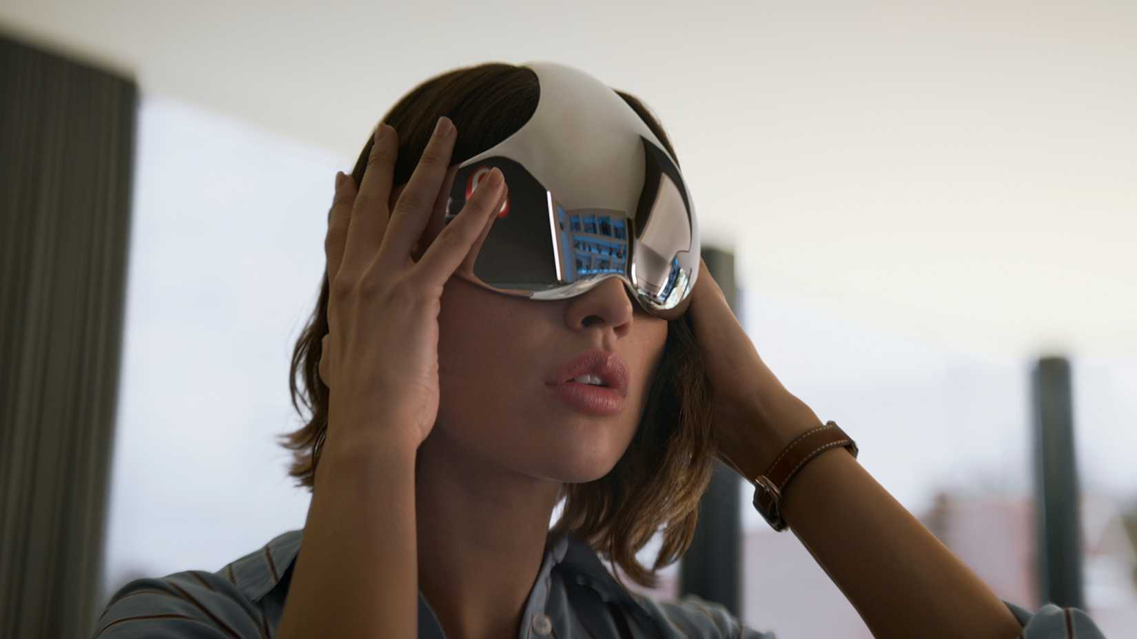 Eiza González as Auggie Salazar putting on a mirrored cap in 3 Body Problem