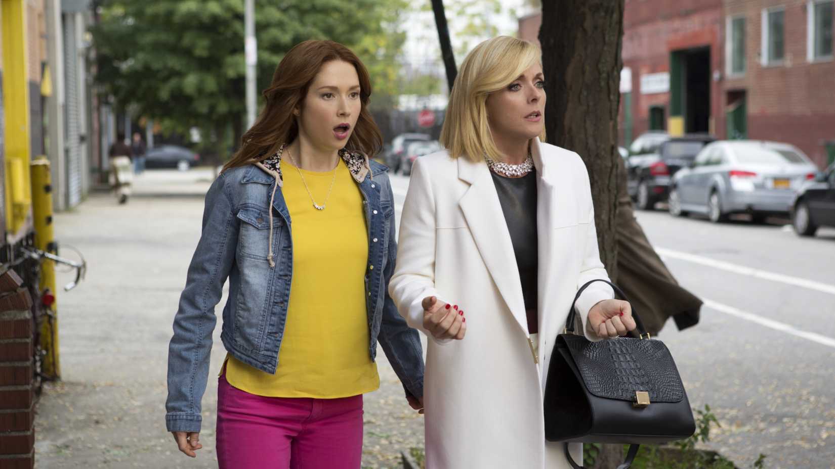 Ellie Kemper and Jane Krakowski looking shocked in Unbreakable Kimmy Schmidt