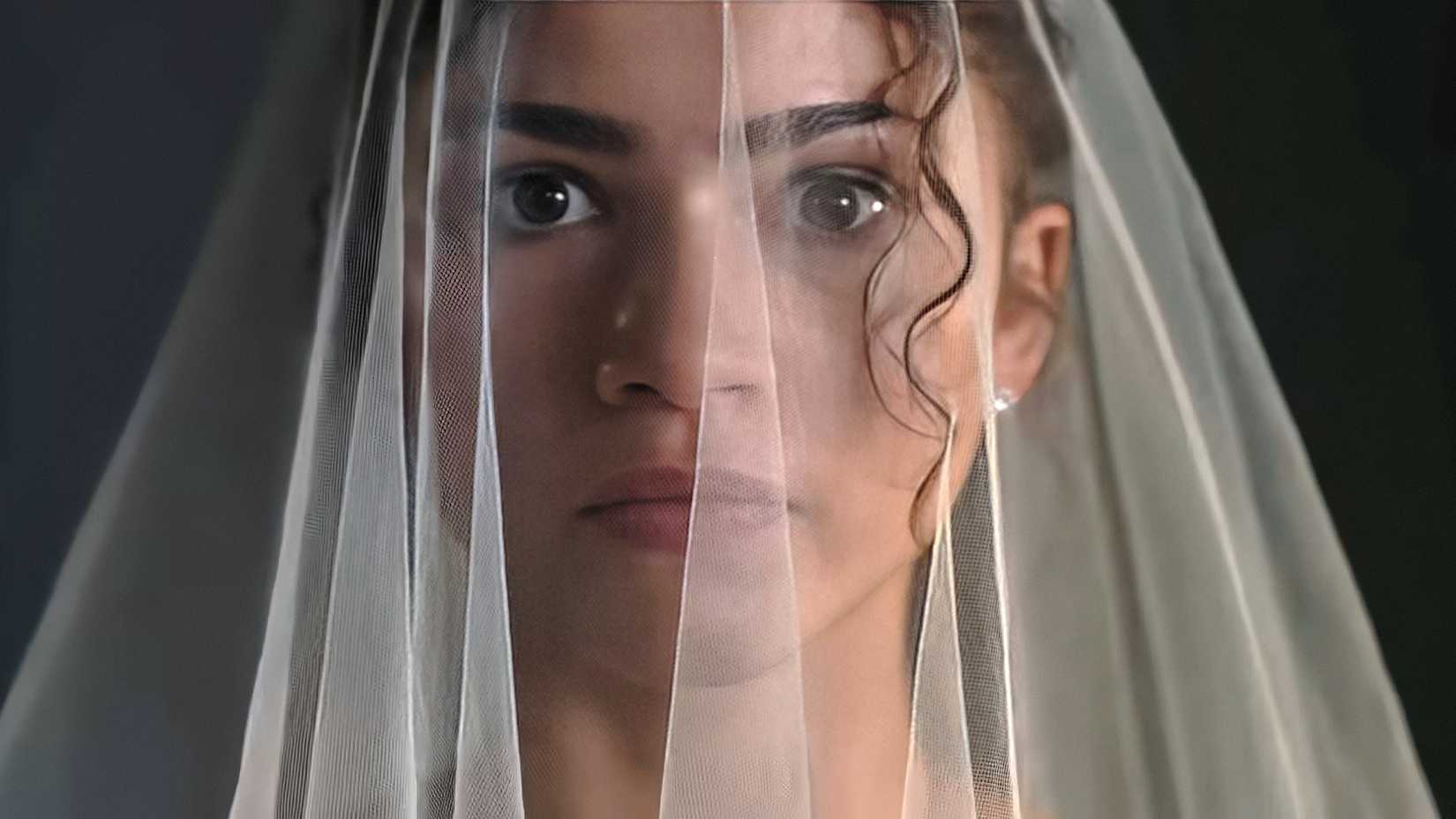 emma in close up wearing a wedding veil in the drama