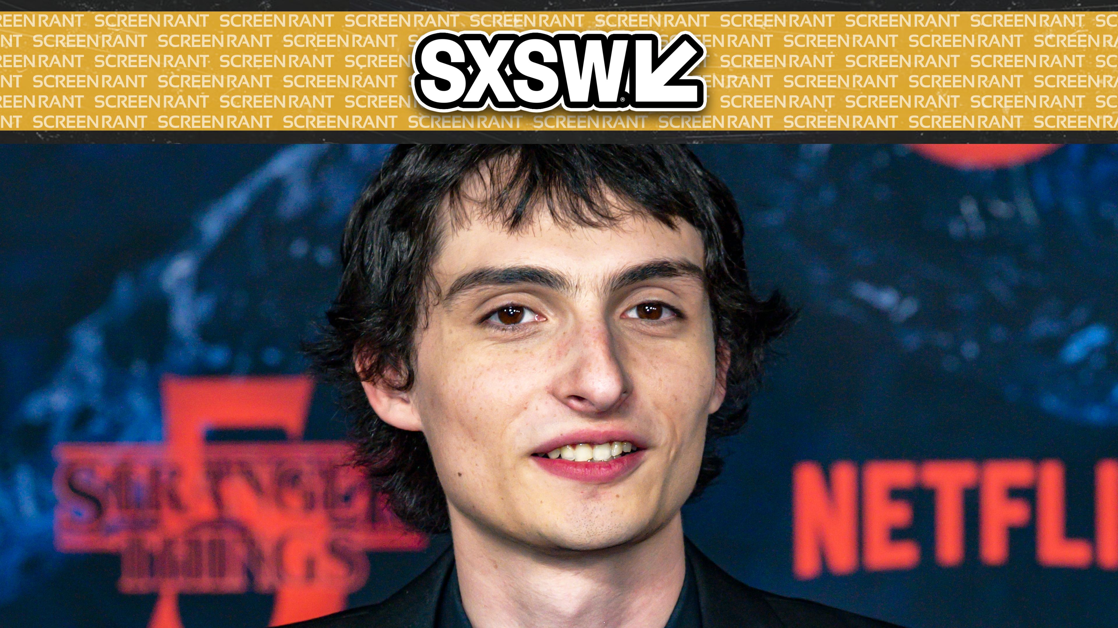Finn Wolfhard smiling while on the Stranger Things season 5 red carpet SXSW