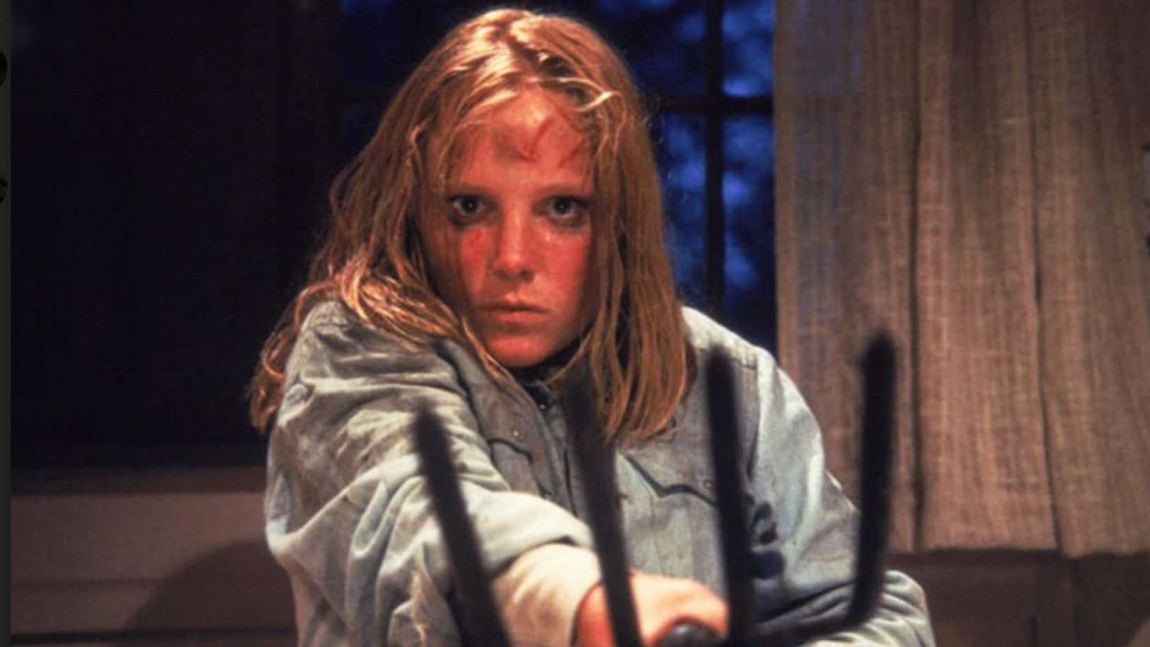 A woman holds a pitchfork at the camera in Friday the 13th Part 2
