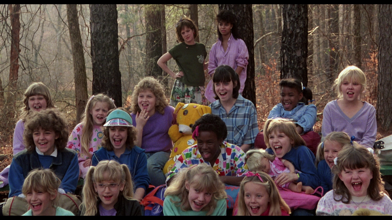 A crowd of kids at Camp Forest Green (aka Camp Crystal Lake) cheering in excitement for the summer ahead