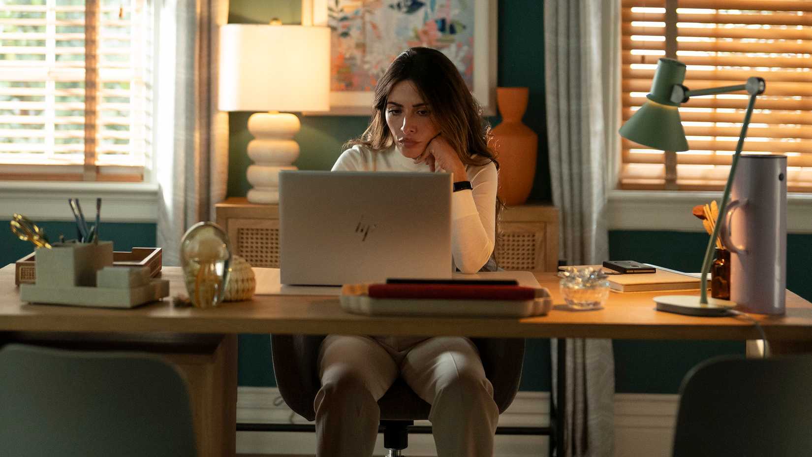 Why Jane Is Really Working For Sinatra 3 Gabriela (Sarah Shahi) sitting at her desk looking at her laptop in Paradise season 2