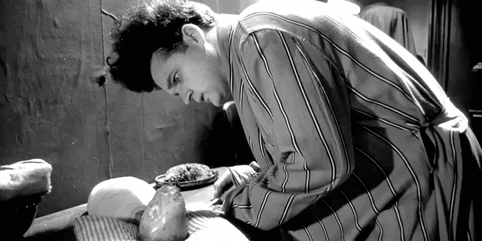 Henry trying to feed his baby in Eraserhead